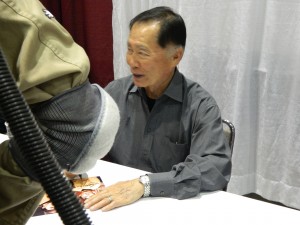 George Takei signs for a fan