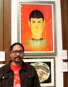 Artist Stanley Chow with his work